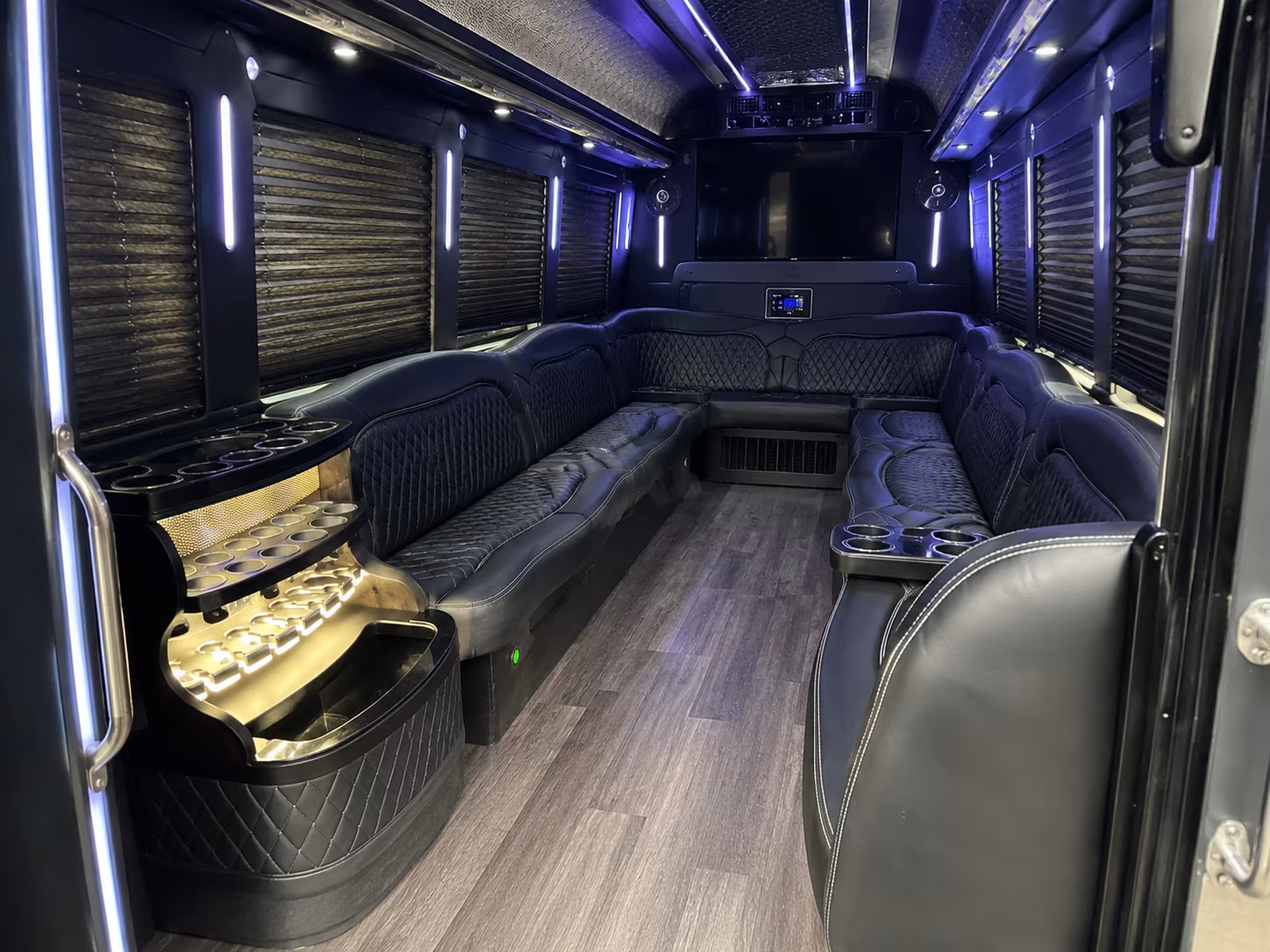 Friends laughing during a party bus celebration in San Antonio